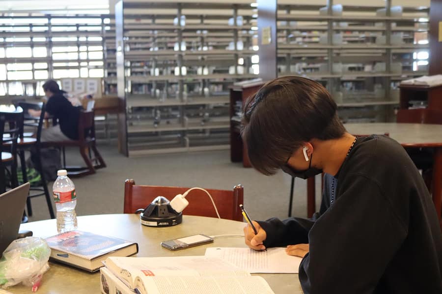 Tommy Nguyen listens to music to help him focus while he catches up on schoolwork.
