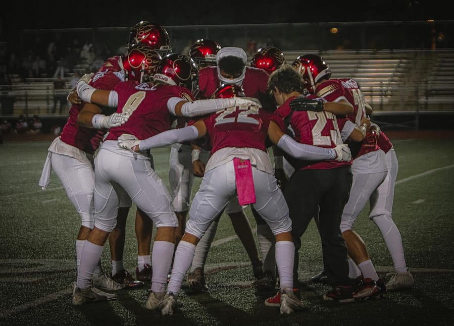 Grizzlies Huddle And Prepare For Victory Against Torrey Pines 10/14/22 Pink Out Game